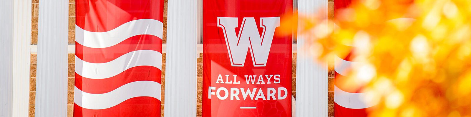 A flag on Bascom Hall reads: "W - All Ways forward."