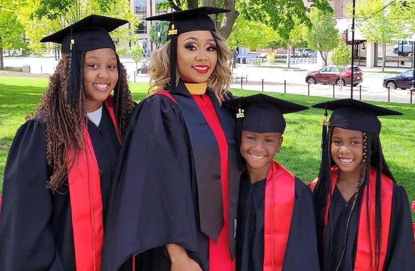 Dominique Christian and her daughters standing together in caps and gowns