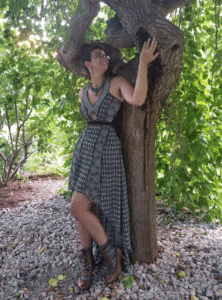 Carly Major leaning against a tree