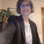 selfie of Christine Gerbitz, in a suit and smiling