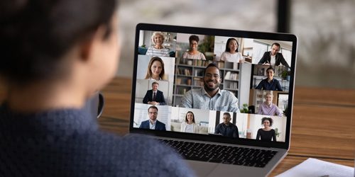 Woman in video conference with her coworkers