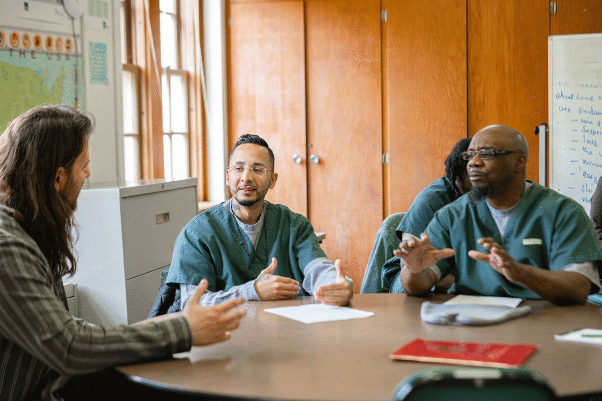 students talking in a prison education course