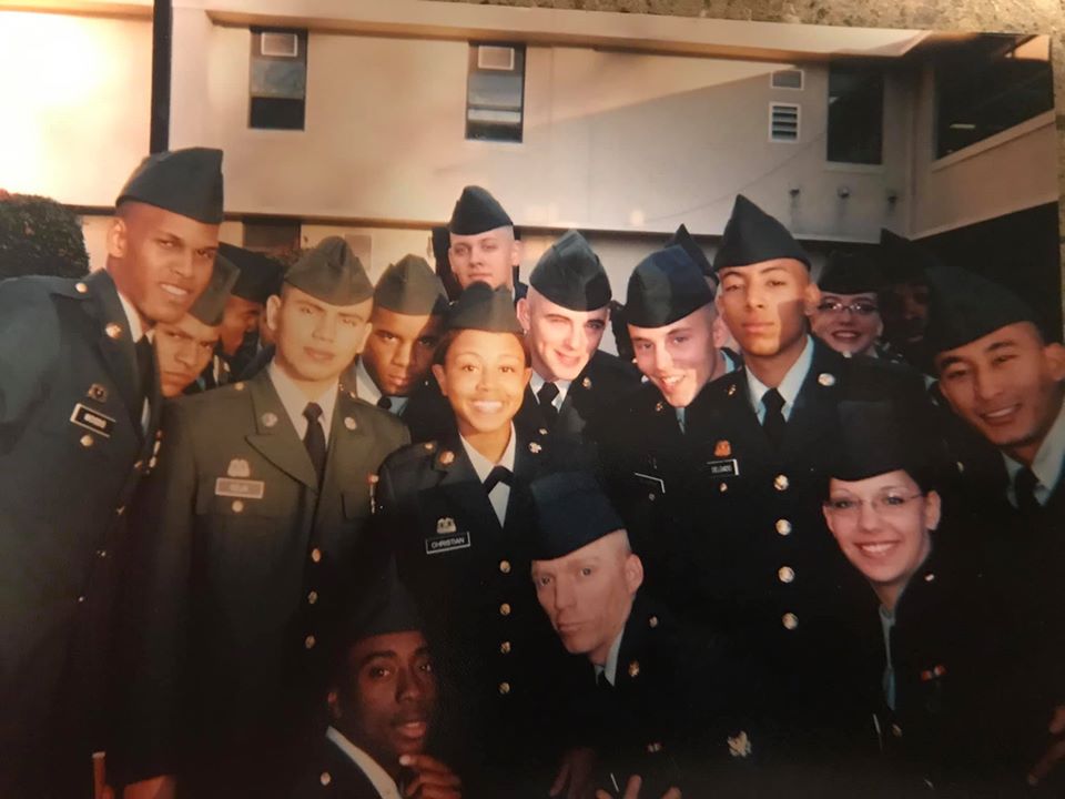 Dominique Christian with her U.S. Army personnel, standing in a group and smiling in uniforms