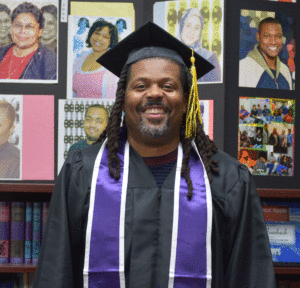 Corey Saffold, smiling, in his cap and gown