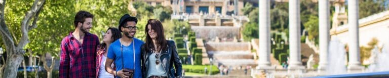 A happy group of friends walk through Barcelona