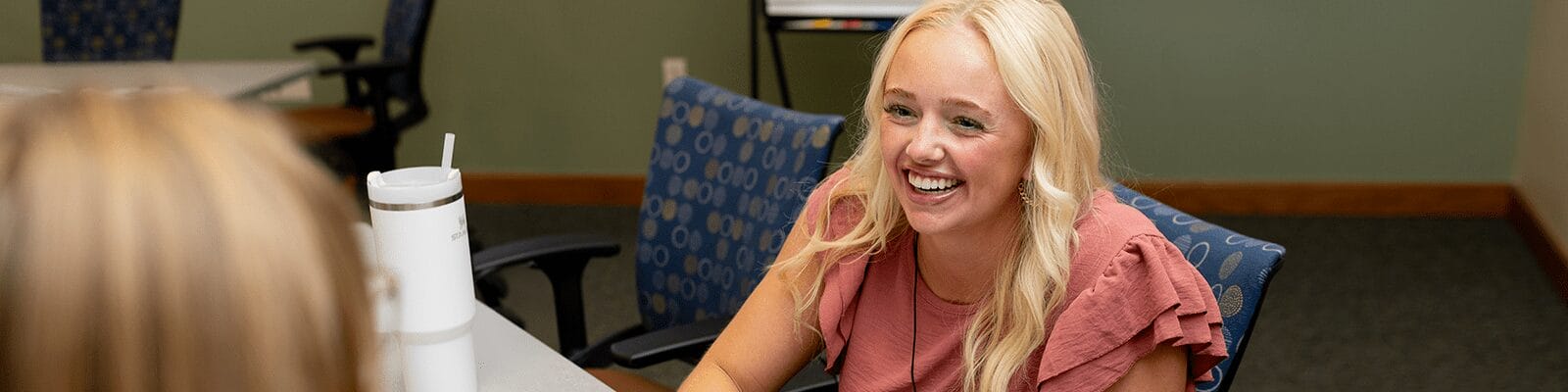 Woman smiling during Professional Coaching course