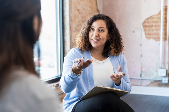 Coach meeting with her client one-on-one